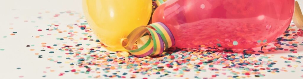 Balloons laying on a surface covered in confetti