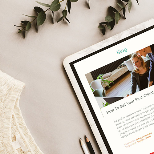 Cropped image of table with The Designist Studio blog showing on the screen