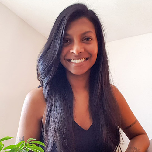 Ruha, web designer and brand strategist, is smiling at the camera