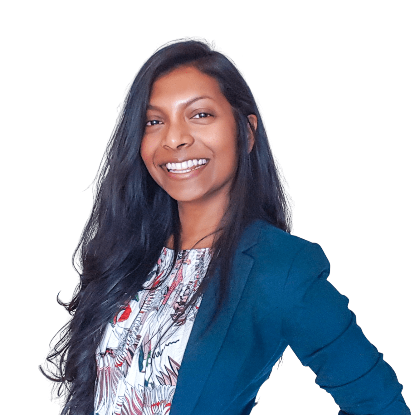 Ruha is smiling at the camera, she's wearing a floral blouse and a teal blazer, and her black hair is worn down.
